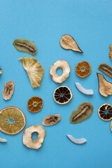 Dried fruits Useful vitamins Kiwi Coconut Pear Orange Banana Mandarin Lime Colored background blue