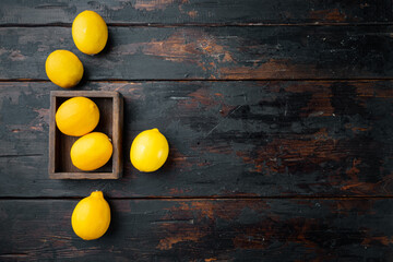 Fototapeta na wymiar Fresh lemons, in wooden box, on dark wooden background, top view flat lay , with copyspace and space for text
