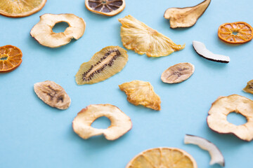 Dried fruits Colored blue background Useful vitamins Kiwi Coconut Pear Orange Banana Mandarin Lime