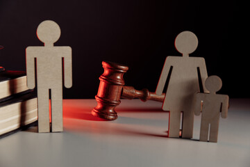 Wooden model of couple and judge gavel. Divorce concept