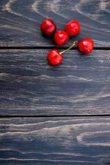 ripe cherries on black background, copy space