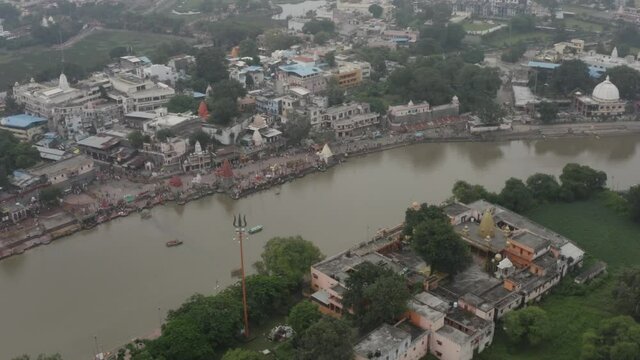 Drone shot of River Shipra with Mahakal Trishul in the foreground. Aerial view of the holy river Shipra of Ujjain, India, with Lord Shiva&rsquo;s Trishul mounted on the top of the Shikhara of Mahakal Templ

