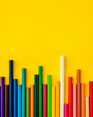 Colored pencils are arranged in a row on a light yellow background. One white pencil sticks out above all. Gradient color. Concept: development jumps, stock exchange jumps.