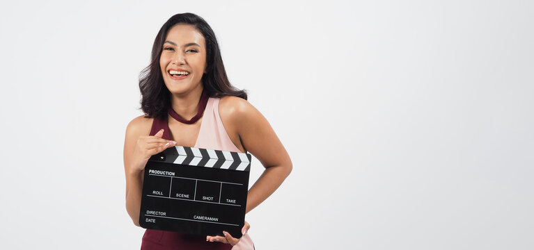 Asian woman is holding clapper board or movie slate use in video production ,film, cinema ,movies industry on white background.