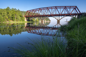 Reflection in the water of the bridge on the Circum-Baikal Railway