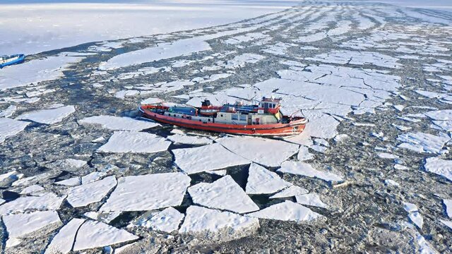 Icebreakers breaking the ice on River in winter.