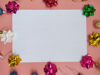 Clear white paper sheet surrounded by Christmas decorations and bows