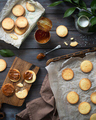 Shortbread cookies with salted caramel. Preparation of dessert. Cookies on a wooden table. Cooking sweets