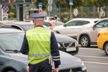 Traffic police officer works on major street in a big city, day time