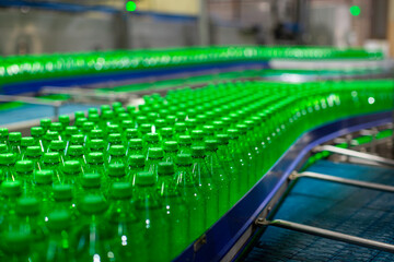 Obraz premium Beverage factory interior. Conveyor flowing with bottles for water