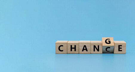 flipping CHANGE to CHANCE word on wooden cube block on blue background, market trend, positive...