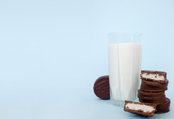 chocolate chip cookies with milk on a blue background, copy space