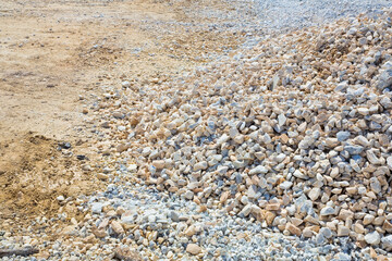 Expanse of different sizes gravel in a construction site used in the construction industry and building activity for the construction of roadbeds