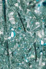Broken glass or mirror texture with bokeh. Abstract winter backround. Ice and cold concept
