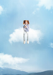 Conceptual collage with little beautiful girl sitting on white cloud using phone and flying at sky, outdoors. Concept of childhood, happiness, dreams, adventure