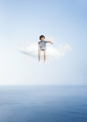 Creative collage with little preschool boy sitting on white cloud and flying at sky, outdoors. Concept of childhood, happiness, dreams, adventure