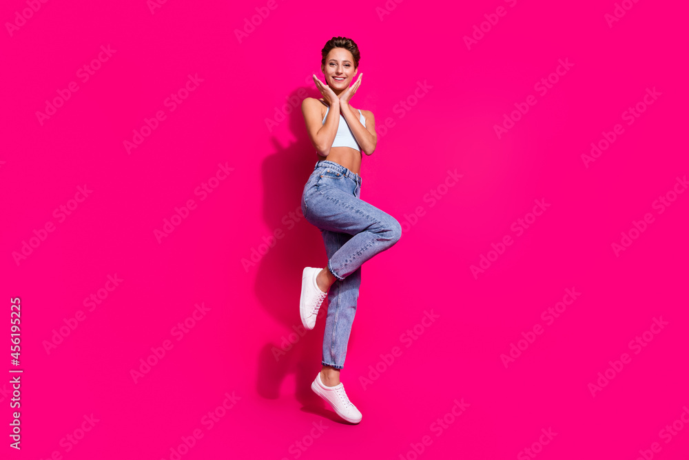 Wall mural Full length body size view of attractive cheerful girl jumping having fun isolated over bright pink magenta color background