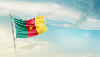 Cameroon national flag cloth fabric waving on the sky with beautiful sun light - Image