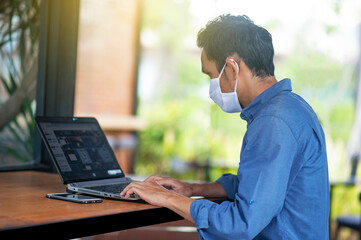 Asian man freelance working  at cafe