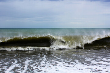 Beautiful seascape with wavy water on the background of cloudy sky