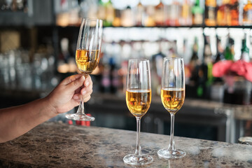 closeup hand of man holding glass of champagne