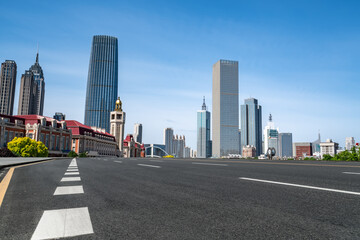 Naklejka premium Road and city buildings background