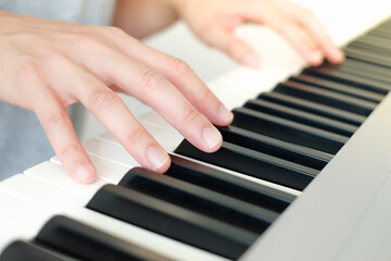 Fototapeta premium Close up man's hand playing piano