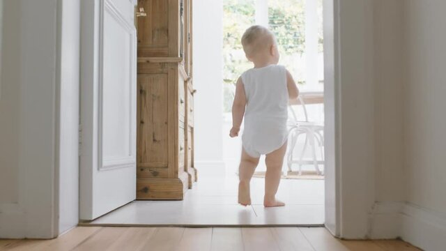 baby boy learning to walk toddler exploring home curious infant walking through house enjoying childhood