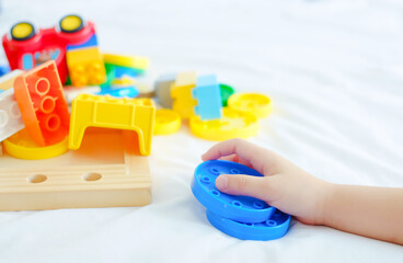 small child hand with plastic toys