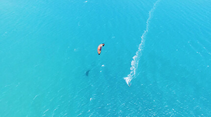 Aerial view of kitesurfing extreme sport with the wind freestyle. Beautiful top view of nice beach.