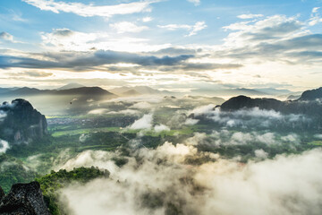 The sunrise shine mountains, hill and beautiful sea of mist to cover forest in countryside at Vang Vieng, Laos