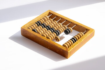 Old little wooden abacus. Vintage item on a white background