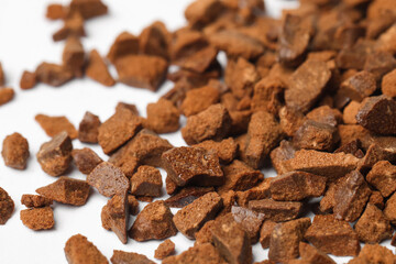 Pile of chicory granules on white background, closeup