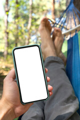 Cellphone with the empty white screen for your mockup in a man's hand