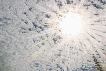 Sunlight shining through the  white clouds in blue sky background