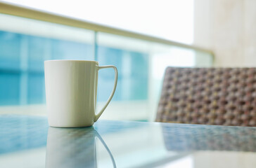 white coffee cup on the table with outdoor view in  terrace