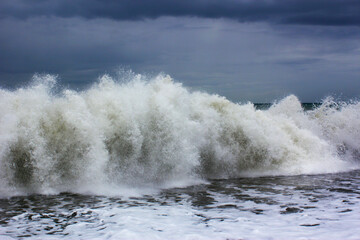 Beautiful view of a wavy sea with foamy water under a cloudy sky