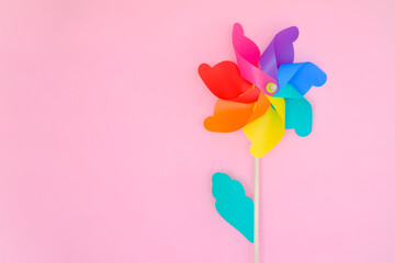 colorful wind turbine or pinwheel or wind toy on pink background