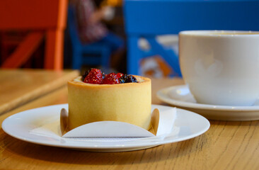 vanilla cheesecake and  cappuccino in a white mug