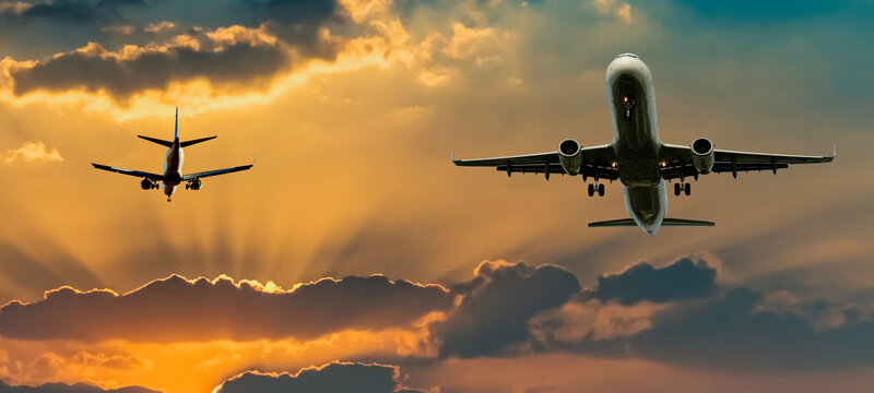 Colorful sunrise with clouds landing and taken off airplanes, concept of travels and vacations © sergei_fish13