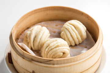 Chinese steamed buns Baozi in basket isolated on white background