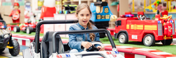 Moscow, Russia, 28 May 2021 - little happy kid girl fun riding an small electric cars on sport...