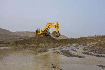 An excavator works in an open-pit gold mine.