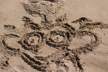 children drawing  on sand