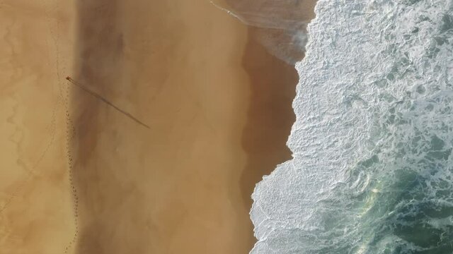 Lonely man walks within idyllic island with massive tides. Drone footage of the beautiful seaside landscape for inspirational background. High quality 4k footage