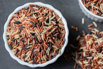 Jasmine Brown Rice in wooden bowl with copy space, Thai rice varieties Top view