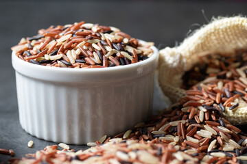 Jasmine Brown Rice in wooden bowl with copy space, Thai rice varieties Top view