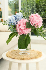 Bouquet with beautiful hortensia flowers on table in living room
