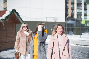 Three beautiful Russian girls are having fun on the street