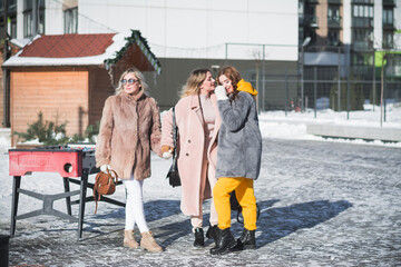 Three beautiful Russian girls are having fun on the street